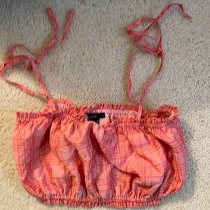 Pink plaid tank top with tied spaghetti straps at the top